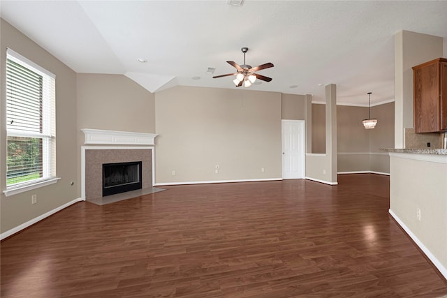 7431 Pony Crk, Missouri City, TX 77459 - unfurnished living room featuring a ceiling fan, dark wood-type flooring, a fireplace with flush hearth, baseboards, and lofted ceiling