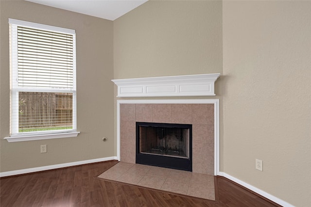 7431 Pony Crk, Missouri City, TX 77459 - detailed view of wood finished floors, baseboards, and a fireplace
