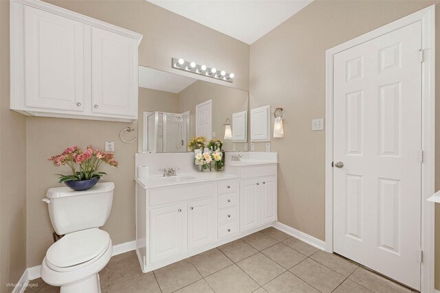 7431 Pony Crk, Missouri City, TX 77459 - bathroom featuring baseboards, tile patterned floors, a stall shower, and double vanity