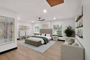 bedroom featuring attic access, multiple windows, recessed lighting, and light wood finished floors