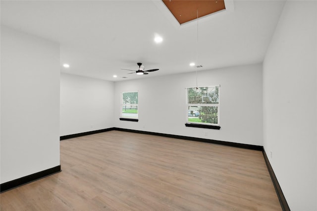 unfurnished room featuring attic access, recessed lighting, light wood-type flooring, baseboards, and a ceiling fan