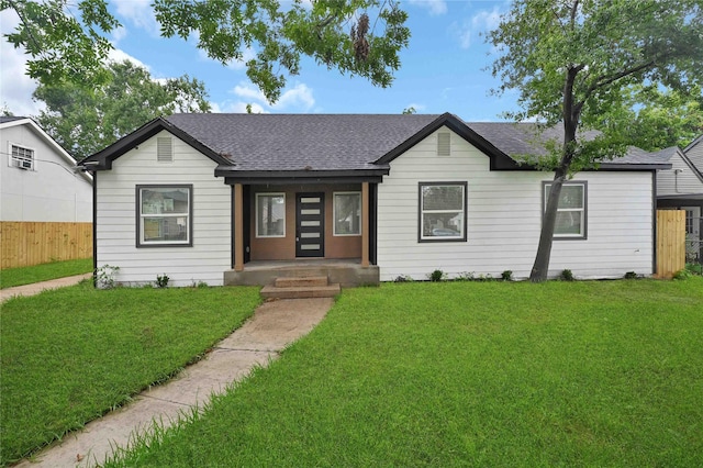 ranch-style house with a shingled roof and covered porch