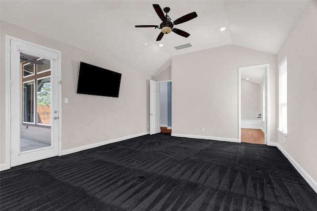 unfurnished bedroom featuring dark carpet, visible vents, access to exterior, and vaulted ceiling