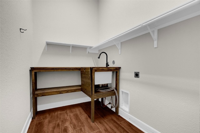 laundry room with laundry area, electric dryer hookup, baseboards, and wood finished floors