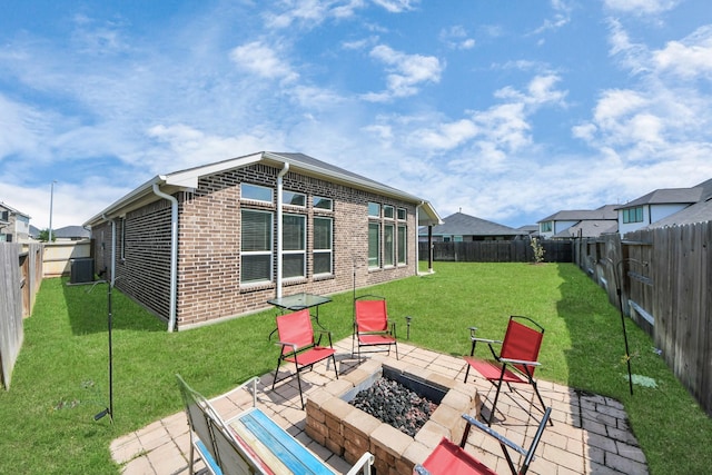 back of house featuring brick siding, an outdoor fire pit, central air condition unit, and a patio area