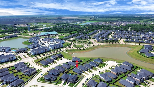 view of property location featuring a large body of water and nearby suburban area