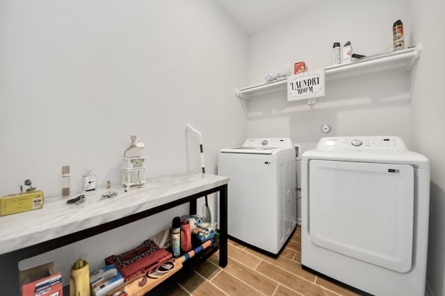 washroom featuring washing machine and clothes dryer and wood finish floors