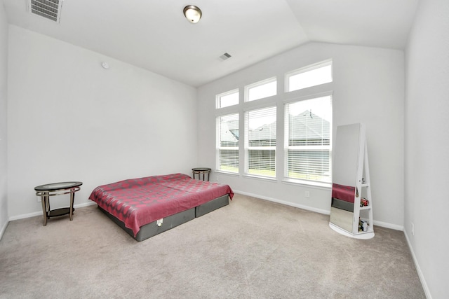 carpeted bedroom featuring vaulted ceiling and baseboards