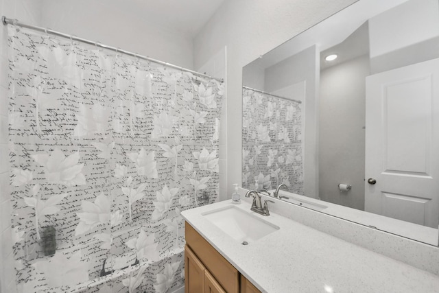 full bath with vanity and a shower with shower curtain