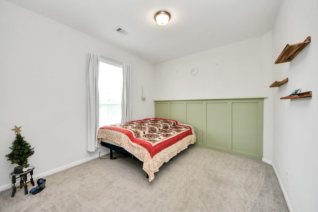carpeted bedroom featuring baseboards