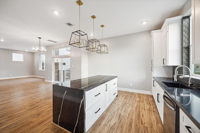kitchen with baseboards, dishwasher, a center island, a notable chandelier, and light wood-style floors