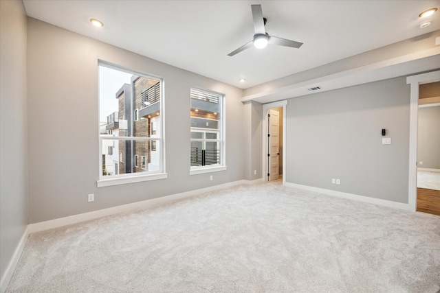 carpeted spare room featuring baseboards, a ceiling fan, visible vents, and recessed lighting