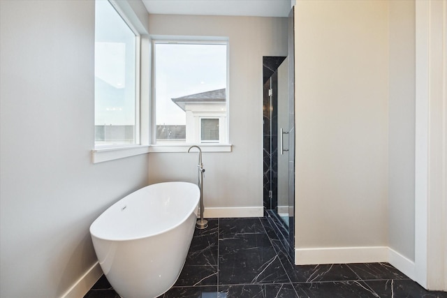 bathroom with marble finish floor and baseboards