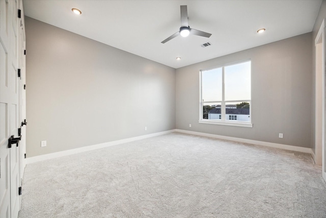 empty room featuring light colored carpet, baseboards, a ceiling fan, and recessed lighting