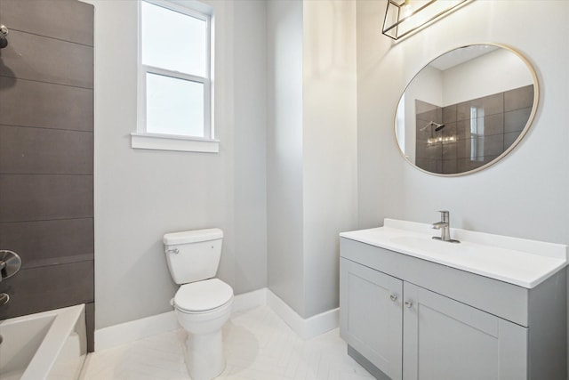 bathroom featuring toilet, baseboards, and vanity