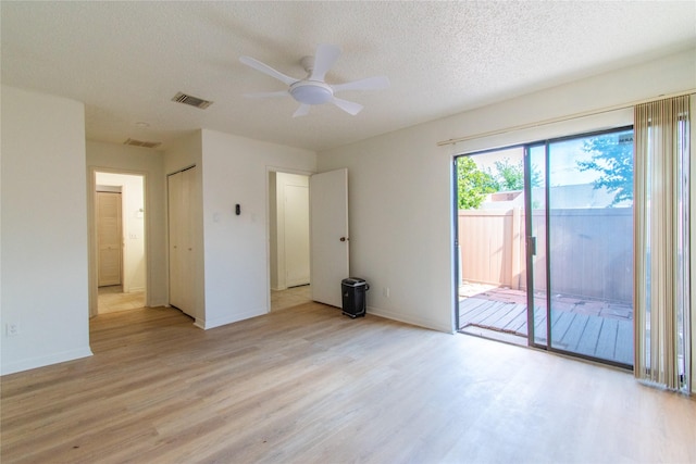 2429 Briarwest Blvd, Houston, TX 77077 - spare room featuring light wood-type flooring, a ceiling fan, a textured ceiling, and baseboards
