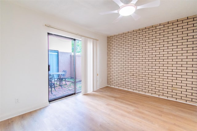 2429 Briarwest Blvd, Houston, TX 77077 - unfurnished room with wood finished floors, ceiling fan, baseboards, and brick wall