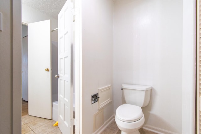 2429 Briarwest Blvd, Houston, TX 77077 - bathroom with toilet, tile patterned floors, a textured ceiling, and baseboards