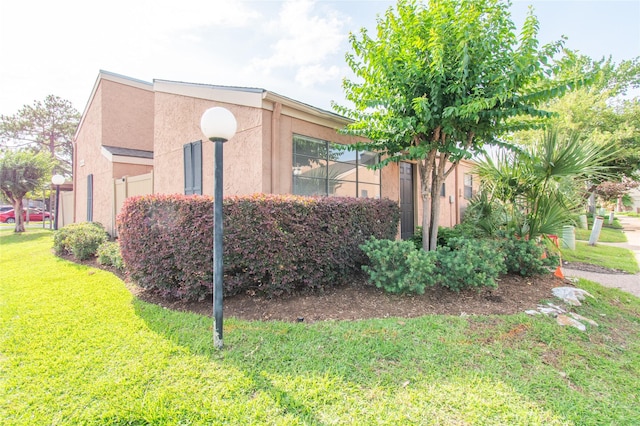 2429 Briarwest Blvd, Houston, TX 77077 - view of property exterior with a lawn and stucco siding