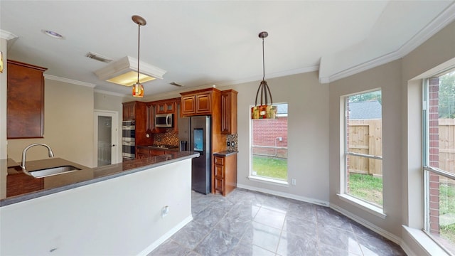 kitchen with plenty of natural light, visible vents, a sink, backsplash, and stainless steel appliances