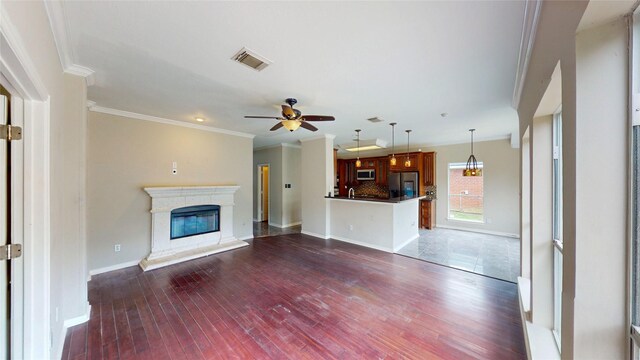 unfurnished living room featuring visible vents, baseboards, ceiling fan, ornamental molding, and dark wood-style floors