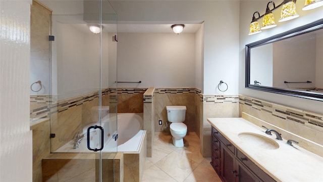 full bathroom featuring tile walls, a shower with shower door, toilet, a tub to relax in, and tile patterned floors