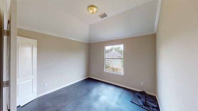 spare room with lofted ceiling, visible vents, crown molding, finished concrete flooring, and baseboards
