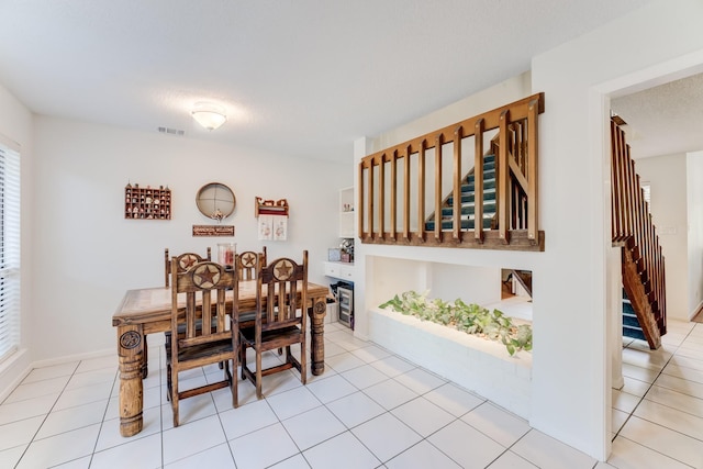 dining room with stairs, visible vents, and light tile patterned flooring