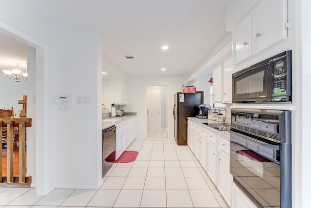 kitchen with black appliances, visible vents, a chandelier, white cabinetry, and light countertops