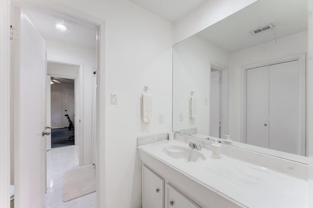 bathroom with marble finish floor, vanity, and visible vents