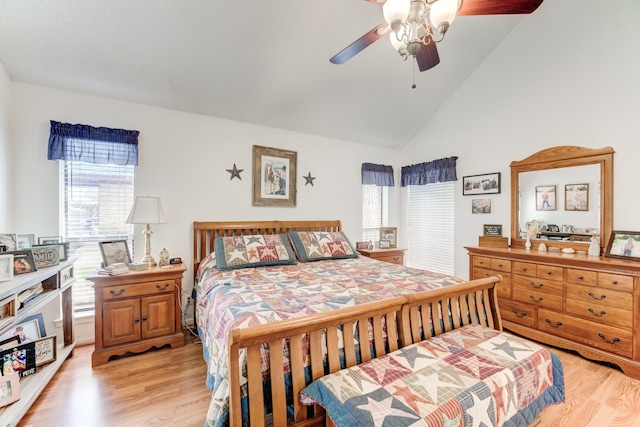 bedroom with light wood-style floors, a ceiling fan, and high vaulted ceiling