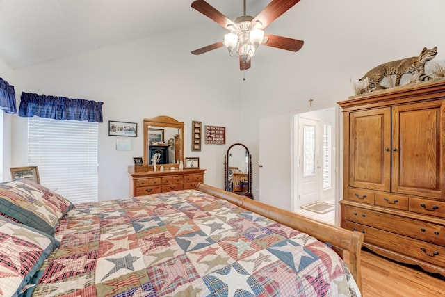 bedroom featuring light wood-style floors, ceiling fan, and high vaulted ceiling