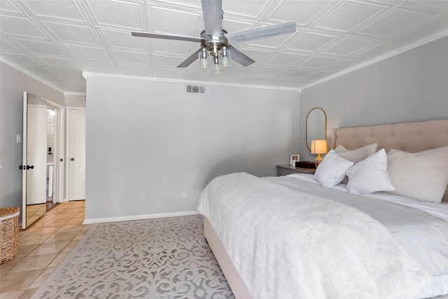 bedroom with an ornate ceiling, a ceiling fan, crown molding, light tile patterned floors, and baseboards