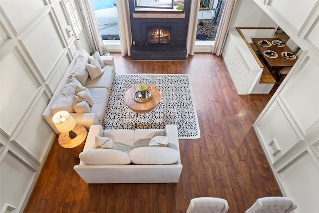 living area with a fireplace and hardwood / wood-style flooring