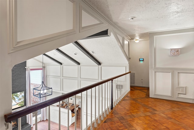 hall with a textured ceiling
