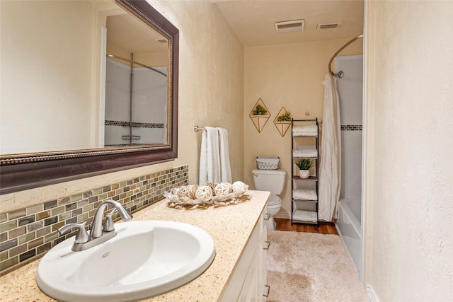 full bathroom featuring decorative backsplash, toilet, vanity, shower / bath combination with curtain, and wood finished floors