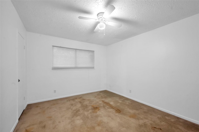 2422 Deasa Dr, Spring, TX 77373 - empty room featuring a textured ceiling, carpet flooring, baseboards, and a ceiling fan