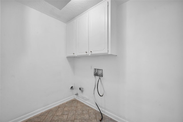 2422 Deasa Dr, Spring, TX 77373 - clothes washing area with cabinet space, a textured ceiling, hookup for a gas dryer, baseboards, and hookup for a washing machine