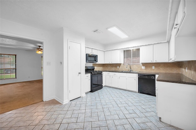 2422 Deasa Dr, Spring, TX 77373 - kitchen with dark countertops, white cabinetry, ceiling fan, black appliances, and tasteful backsplash