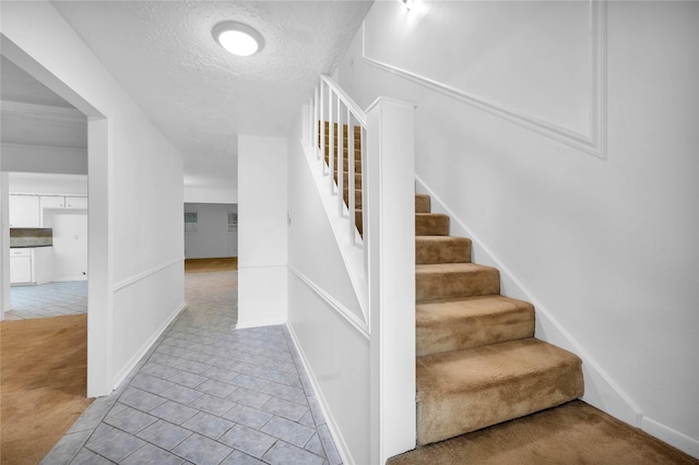 2422 Deasa Dr, Spring, TX 77373 - stairway with carpet, a textured ceiling, tile patterned flooring, and baseboards