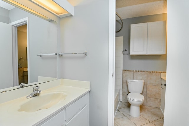full bath with vanity, tile walls, toilet, and tile patterned floors