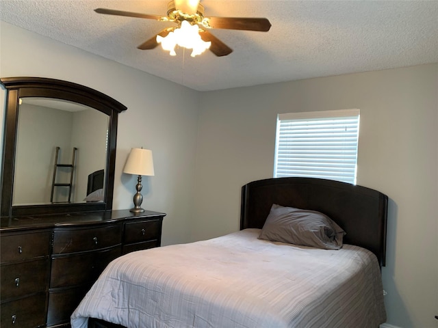bedroom featuring a ceiling fan and a textured ceiling