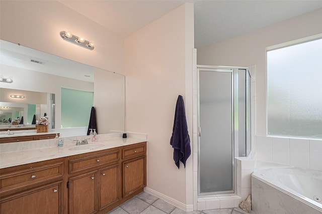 full bathroom featuring a stall shower, vanity, a bath, and tile patterned floors