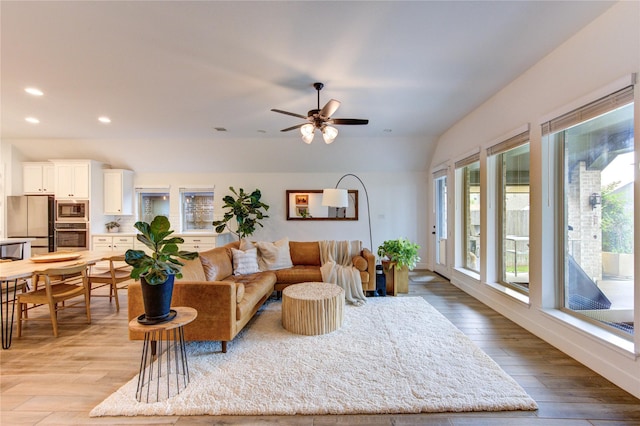 20447 Avelignese Way, Tomball, TX 77377 - living room featuring light wood-type flooring, vaulted ceiling, ceiling fan, and recessed lighting