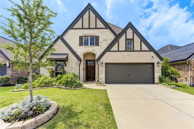 20447 Avelignese Way, Tomball, TX 77377 - tudor home with stone siding, concrete driveway, brick siding, and a front yard