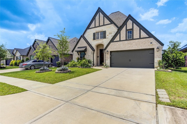 20447 Avelignese Way, Tomball, TX 77377 - tudor house featuring stone siding, a garage, concrete driveway, a front lawn, and brick siding