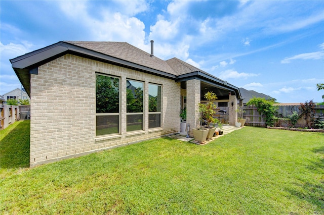 20447 Avelignese Way, Tomball, TX 77377 - rear view of property with brick siding, roof with shingles, a lawn, and a fenced backyard