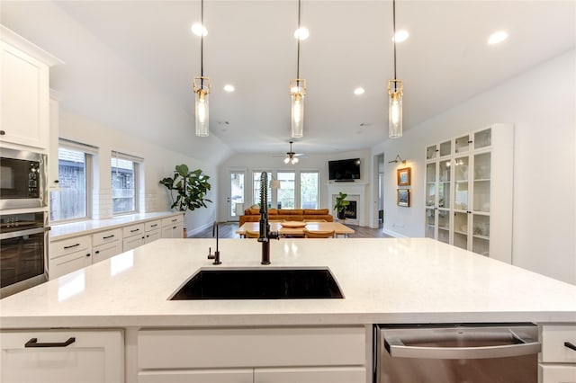 20447 Avelignese Way, Tomball, TX 77377 - kitchen featuring a sink, stainless steel appliances, a fireplace, and recessed lighting