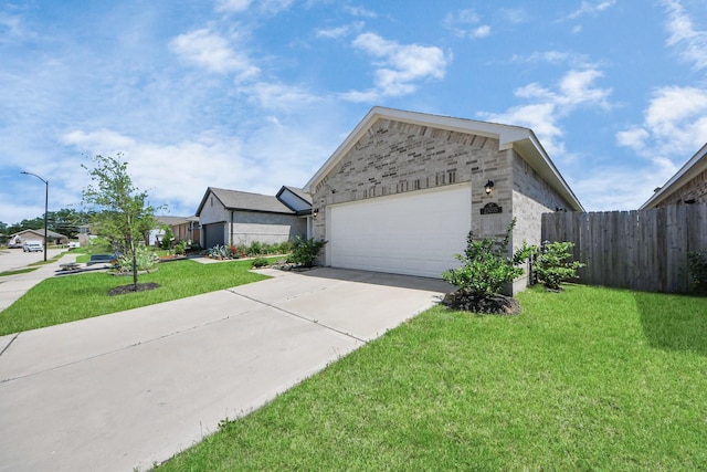 single story home featuring a garage, fence, driveway, and a front yard