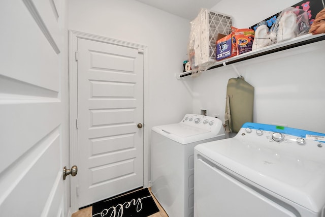 clothes washing area featuring washer and clothes dryer and laundry area